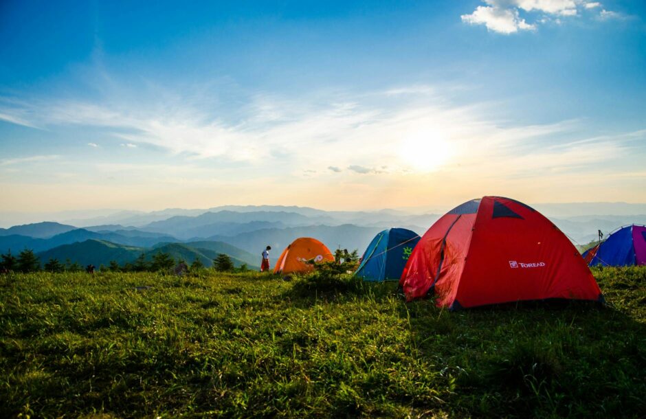 photo of pitched dome tents overlooking mountain ranges