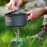 man using a camping gas stove