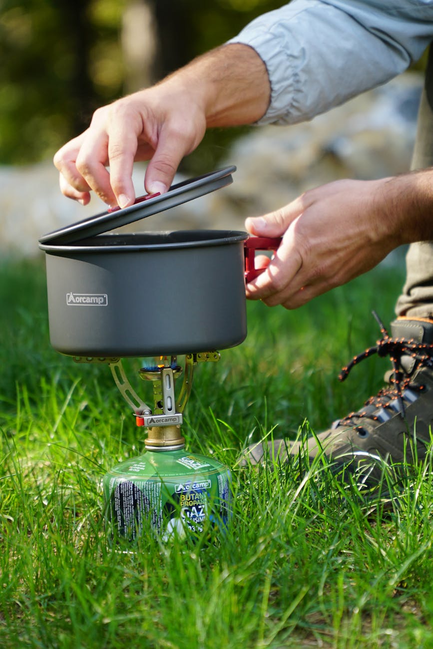 man using a camping gas stove